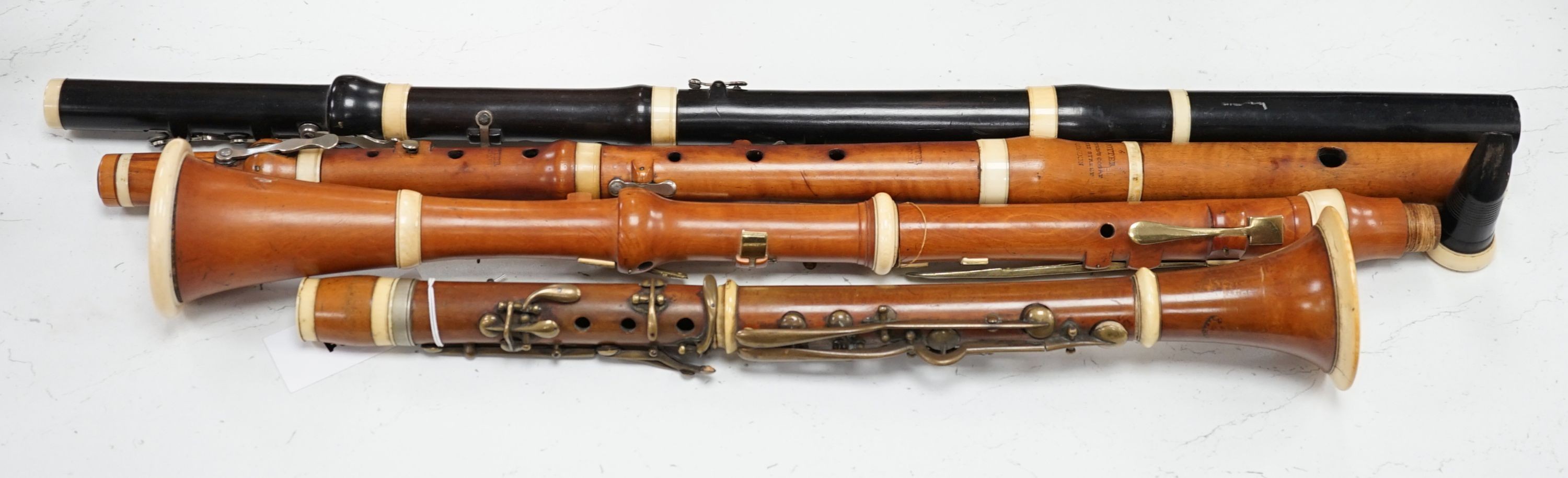 Two 19th century flutes by W. Potter, one in boxwood, the other ebony, and two 19th century boxwood clarinets, one by Dollard, the other by Lazarus